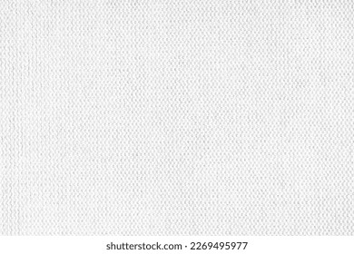 Close-up texture of natural white coarse weave fabric or cloth. Fabric texture of natural cotton or linen textile material. White canvas background. Decorative fabric for upholstery, furniture, walls