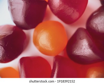 Close-up Texture Of Red, Orange And Purple Multivitamin Gummies. Healthy Lifestyle Concept.