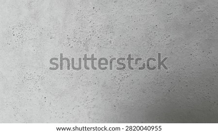 Closeup texture of a rough, light gray concrete wall with small pores and natural imperfections, suitable for architectural backgrounds and design projects