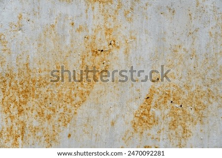 A close-up texture of a rusty metal surface with a white paint base. The surface shows signs of wear and tear with patches of rust and peeling paint