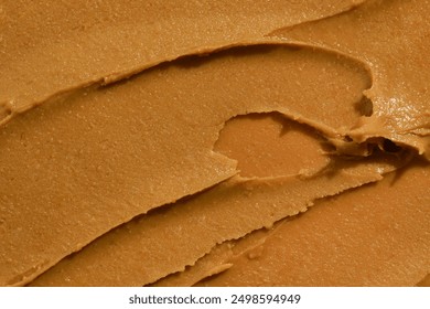 Close-up texture of smears of creamy peanut paste. Nut butter concept, protein source, food, ingredients. Image for your design - Powered by Shutterstock