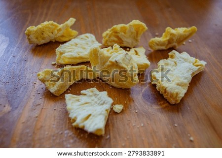 Close-up and texture of sublimated pineapples. Concept of proper nutrition and healthy sugar-free snacks.