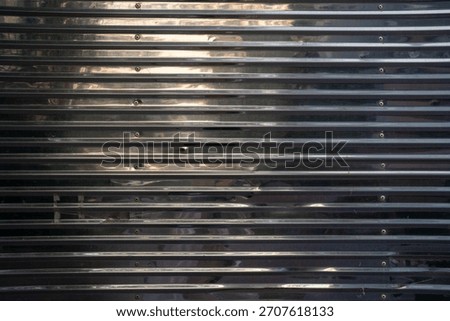 Close-up of textured metallic surface with parallel lines.