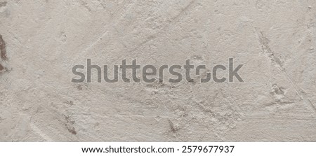 Close-up of a textured off-white surface with subtle brown speckles and visible brush strokes.