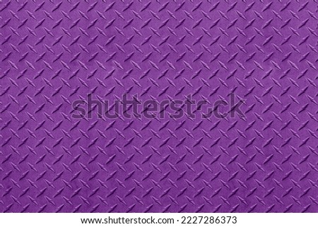 Closeup of textured purple metal diamond plate background.