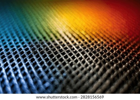 Close-up of a textured surface with a rainbow spectrum of light refracted across it, creating a vibrant and abstract visual.