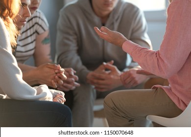Close-up of a therapist gesticulating while talking to a group of listing teenagers during an educational self-acceptance and motivation meeting. - Shutterstock ID 1150070648