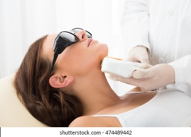 Close-up Of A Therapist Giving Laser Epilation Treatment On Women's Neck