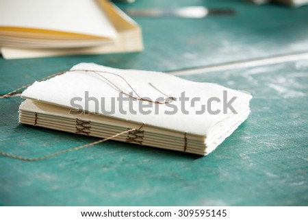 Closeup of thread and papers on table in factory