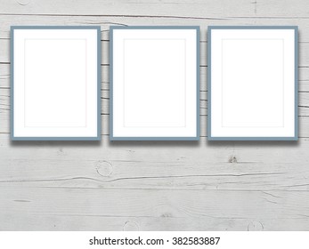 Close-up Of Three Aqua Picture Frames On Light Grey Wooden Boards Background