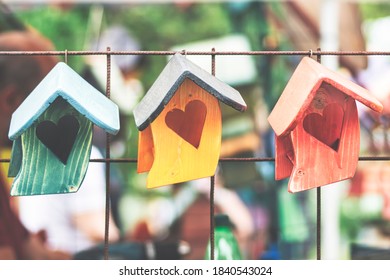 Closeup of three birdhouses with the shape of a heart
 - Powered by Shutterstock