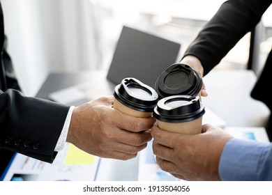 Close-up Of Three Business Men Colliding With Hot Coffee Cups After The Meeting, Business Men Gather To Brainstorm Ideas For Business Growth. Concept Of Business Administration.