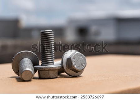 Close-up of three hexagonal flange screws