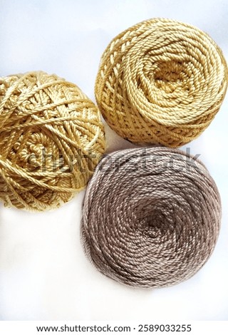 Similar – Image, Stock Photo Close-up of golden yarn bundles in textile production
