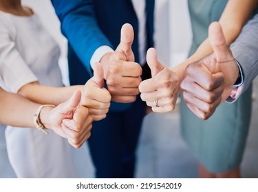 Closeup thumbs up, hand or sign for success, support or trust. Diverse group or team of business men, women or colleagues showing thumb as thank you or approval to idea plan, strategy or good news - Shutterstock ID 2191542019
