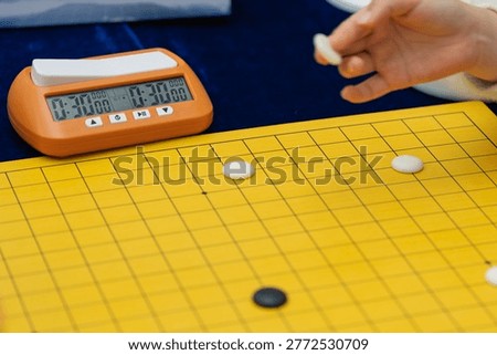 Close-up of timer and stone in Go match