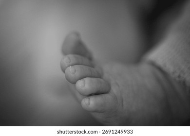 Close-up of a baby’s tiny foot on a soft background. A tender moment capturing the innocence and warmth of early childhoo