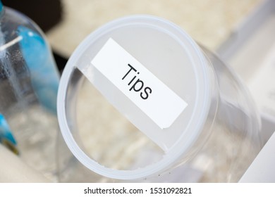 A Closeup Of A Tip Jar In A Restaurant Setting.