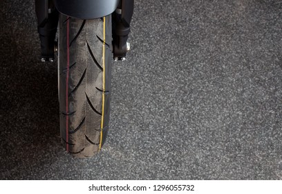 Closeup Tire Of  Sport Motorcycle ( Big Bike ) With Soft-focus And Over Light In The Background. Top View