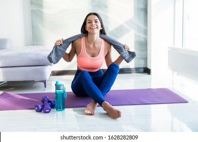 Closeup Of Tired After Sport Young Fitness Girl With Towel And Water At Home