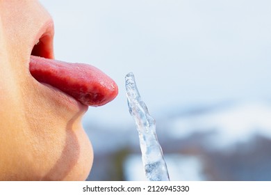 Close-up Of Tongue Licking A Frozen Icicle