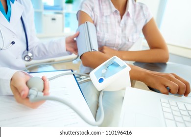 Close-up of tonometer by patientÃ?Â¢??s arm during blood pressure measuring at medical consultation