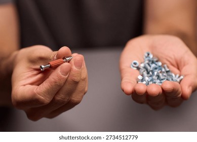 Closeup of tools and craftsmanship. Focus on detailed hand positioning and metal work. Intimate shot emphasizing precision in smallscale metal assembly craftsmanship
