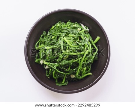 Close-up and top angle view of seasoned spinach with sesame seed on black jar, South Korea
