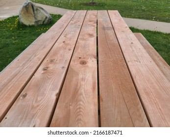 A Closeup Top Down View Of A Wooden Picnic Table.