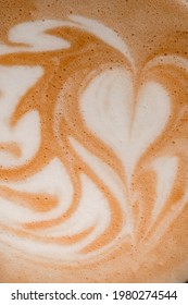 Close-up Top View Of Beautiful White Milk Art Patterns On Brown Foam Of Coffee Drink.