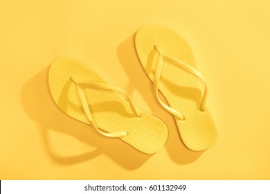 Close-up top view of comfortable yellow flip-flops isolated on yellow - Powered by Shutterstock