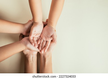 Closeup top view family hands stack palms studio shot isolated on pastel background, parents and kid holding empty free space on hand together, Gesture sign of support and love, Family and parents day - Powered by Shutterstock