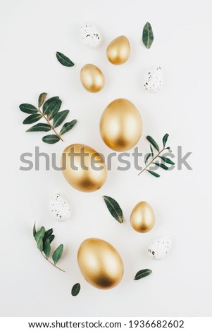 Close-up top view of golden Easter eggs on white background, Happy Easter minimal concept