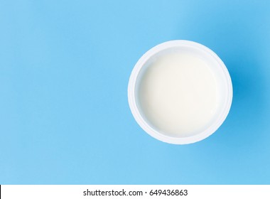 Closeup Top View Greek Yogurt In White Cup With Blue Background