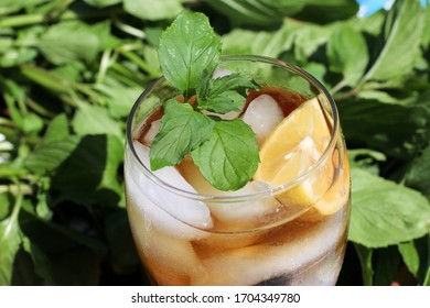 Closeup Top View Looking Down Into Iced Tea Glass , Mint And Lemon Garnish