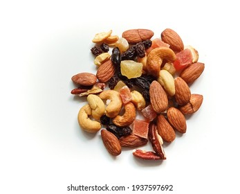 Close-up top view photo of mixed nuts and tropical dry fruits isolated on white background for decoration and design.