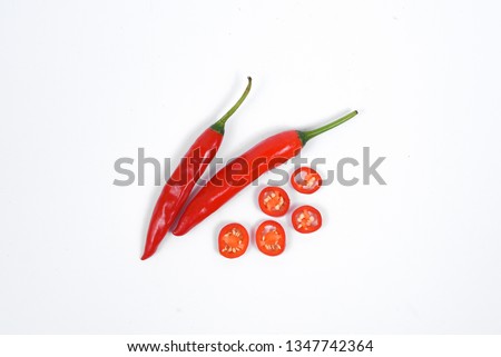 Closeup top view red chili pepper with sliced on white background, raw food ingredient concept 