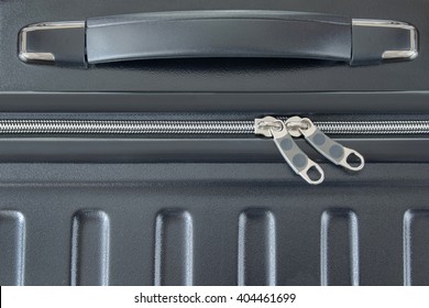 Closeup Top View Of Silver Zipper Of Hard Shelled Suitcase, New And Clean Luggage In Black Color Made Of Polycarbonate Material
