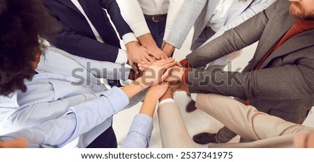 Close-up top view, stacking hands of multicultural business people standing in circle. Corporate unity and support in team. Concept teamwork hands, circle power, common group, business meeting