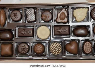 Close-up Top View Of Various Chocolate Pralines. Sweet Food Background. Assortment Of Fine Belgium White, Dark, And Milk Chocolates. Overhead Tray With Selection Of Luxury Praline Chocolates Box.