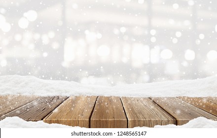 Closeup Top Wood Table With Blur Background And Snow Christmas Time, For Your Photo Montage Or Product Display, Wood Table Top On Blur Christmas Tree In Snow, Space For Placing Items On The Table.