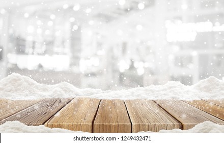 Closeup Top Wood Table With Blur Background And Snow Christmas Time, For Your Photo Montage Or Product Display, Wood Table Top On Blur Christmas Tree In Snow, Space For Placing Items On The Table.