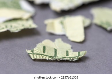 A Closeup Of Torn Money On A Table