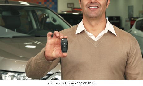 Close-up Of The Torso And Hands Of A Man Who Picks Up Car Keys