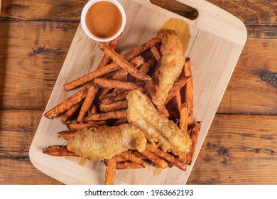 Closeup Of Traditional Fish And Chips Pub Fare, A Crispy Haddock Filet With Sweet Potato French Fried Chips