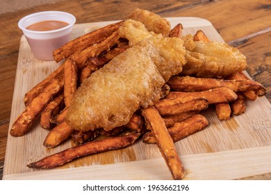 Closeup Of Traditional Fish And Chips Pub Fare, A Crispy Haddock Filet With Sweet Potato French Fried Chips