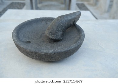 Close-up of a traditional stone mortar and pestle. - Powered by Shutterstock