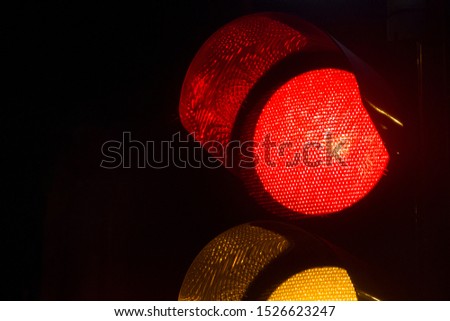 Closeup of a traffic light by night in Israel. Red light.