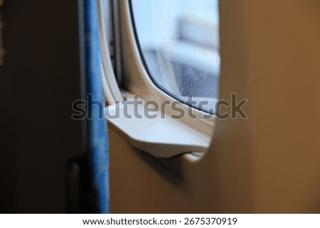 Close-up of a train window with raindrops.