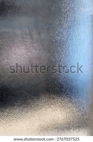 Close-up of translucent bumped glass surface texture for privacy window or shower door.